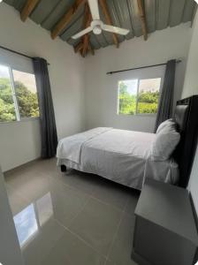 a bedroom with a bed and two windows at Apartamento Luna Llena in Colorado