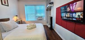 a bedroom with a bed with a flat screen tv at Great Location -Mural, Barn and Corridor -1 Bed 1Bath Apartments! in Windsor