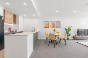 a kitchen and dining room with a table and chairs at Chic Woden Apt, Near Hospital, Westfield w Pool in Phillip