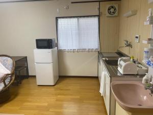 a small kitchen with a sink and a refrigerator at Gohuku - Vacation STAY 41804v in Kami-ichi +36 photos