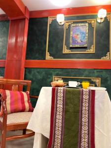 a table with a table cloth on it in a room at Avraham Hotels in Machu Picchu