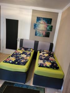 two beds sitting next to each other in a room at Unterkunftsresidenz in Erfurt +42 photos