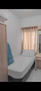 a white bed with a window in a room at Appartemen candiland in Jomblang