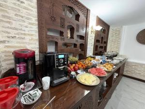 a counter with plates of food and a coffee maker at Porso Boutique Hotel in Bukhara