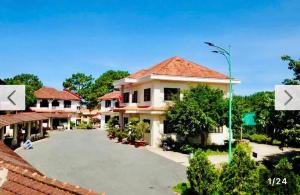 a building with a parking lot in front of it at Resort Hoa Sim Da Lat in Da Lat