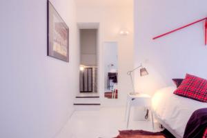 a bedroom with a bed and a table and a hallway at Mons Dragon House in Mons +5 photos
