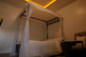 a bedroom with a bed with a canopy at Studio Guest Suite in Nakuru
