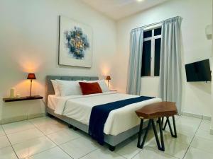 a bedroom with a large bed and a window at Bloc Guesthouse in Pantai Cenang