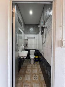 a small bathroom with a toilet and a sink at Taco Shack Diving Hostel Restaurant in Koh Tao