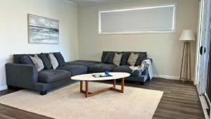 a living room with a couch and a coffee table at La Dolce Vita in Sussex inlet