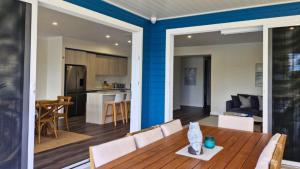a dining room and kitchen with a table and chairs at La Dolce Vita in Sussex inlet +10 photos