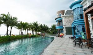 a resort with a swimming pool next to a building at NovaWonderland Ho Tram Villa in Xuyên Mộc +35 photos