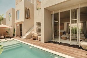 a house with a swimming pool and a patio at NORI Boutique Villas Uluwatu - Breakfast Available in Uluwatu +166 photos