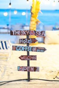 a pole with street signs on the beach at The Sky & Sea Koh Larn in Ko Larn