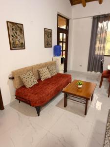 a living room with a couch and a coffee table at Casa Vacacional Valles de Olon in Santa Elena