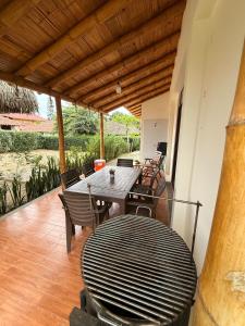 a patio with a table and chairs on a porch at Casa Vacacional Valles de Olon in Santa Elena +20 photos