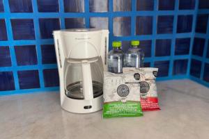 een witte blender op een aanrecht met flessen water bij Beach and Pool Access! in Puerto Vallarta