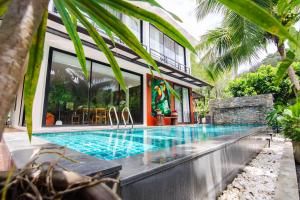 a swimming pool in front of a house at Villa Kanya Aonang in Ao Nang 