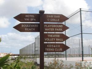 a directional sign in front of a water park at BCV Private 2 Bed Apartment with Pool View Dunas Resort 7009 in Santa Maria