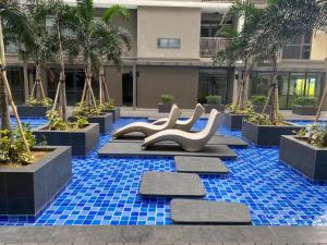 a pool with blue tiles and slides in a building at Cozy Stay with 2beds-Gentry 2mins to Okada- 6B in Sampong