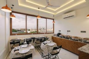 a restaurant with tables and chairs and a counter at Rcc Hotels Biz stays Begumpet in Hyderabad