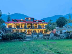 a large house with lights on in a field at Al Yaseen Continental Kalam in Kalām