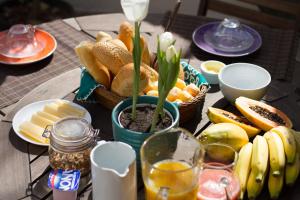 a table with a bunch of bread and other foods at Rede Reserva Copacabana in Rio de Janeiro