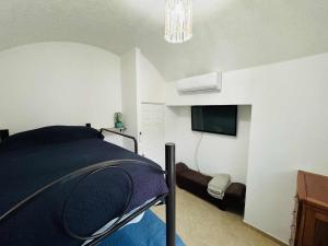a bedroom with a bed and a flat screen tv at Casa con alberca cerca de playas in Ixtapa +24 photos