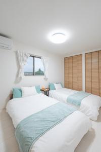 Ένα ή περισσότερα κρεβάτια σε δωμάτιο στο Ishigaki Island villa ACA