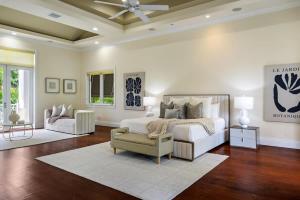 a bedroom with a bed and a couch and a chair at New Luxe Super Villa by The Glam Homes in Plantation