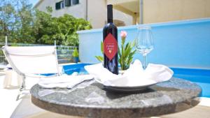uma garrafa de vinho sentada numa mesa com um copo em Villa Hedonica em Zaboric