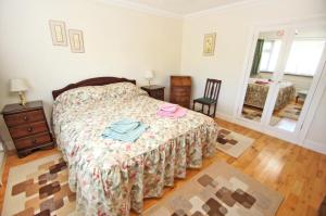 a bedroom with a bed and a table and a window at Dean Court Garden - Parking - by Brighton Holiday Lets in Rottingdean