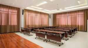 a classroom with tables and chairs in a room with curtains at City Comfort Inn Liuzhou Longtan Park Ma'anshan Baiyun in Liuzhou