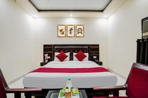 a bedroom with a large bed and two chairs at Hotel Grand Lowsan Airport in New Delhi