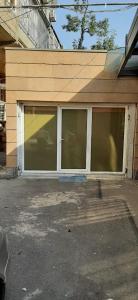 a building with a garage with windows on it at Full Apartment in Yerevan