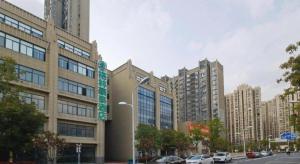 a large building with cars parked in front of it at Green Tree Inn Anhui Hefei Binhu Zhuyuan Metro Station Dali Road in Hefei