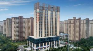 a tall building in a city with tall buildings at Vienna Hotel Shandong Liaocheng High-Tech Zong Yueji Park in Liaocheng