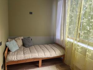 a small bench in a room with a window at SunCoast terrace apartment in Saulkrasti