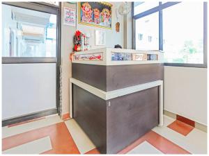 a counter in a room with two windows at Hotel Sea Scape Near Jagannath Temple in Puri