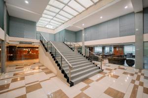 a lobby with a staircase in a building at Shankee Sudirman Jakarta in Jakarta +21 photos
