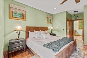 a bedroom with a bed and a lamp on a night stand at Creekside Hideaway at The Farm in Banner Elk