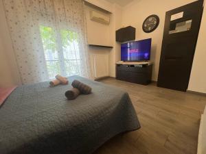 a bedroom with a bed with two towels on it at Jordans appartment in Thessaloniki