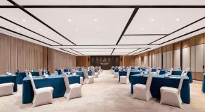 a large room with blue tables and white chairs at Projoy Hotel Tianfu Chengdu in Zhongxingchang +280 photos