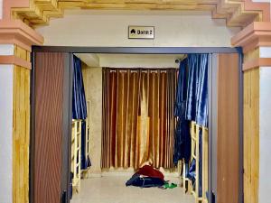 an entrance to a building with a sign that reads mum at Nhật's Sapa Central Hostel in Sapa