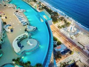 an aerial view of a beach with a water slide at MELLIA OCEANUS NHA TRANG BAY Five-Star Suites in Nha Trang