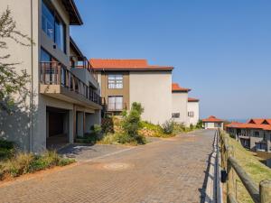 a cobblestone street next to a building at Zimbali Hills 8, Zimbali Estate by Euphoric Leisure in Ballito
