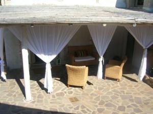 a pavilion with chairs and a bed in a room at Villa Dolce Vita in Cannigione