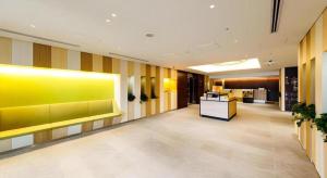 a lobby with a yellow wall in a building at Hotel Dream Gate Maihama Annex in Chiba
