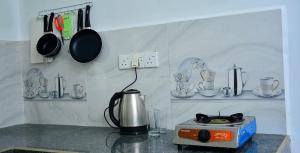 a kitchen with a stove and pots and pans at Angel Haven Villa in Mirissa