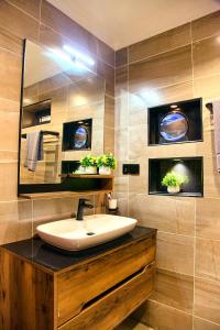 a bathroom with a sink and a mirror at Bhai Apartments in Mwanza +7 photos